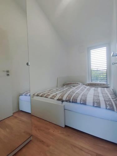 Ένα ή περισσότερα κρεβάτια σε δωμάτιο στο Gaja & Sara Apartments