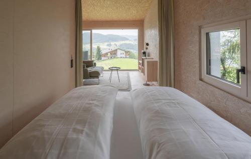 En eller flere senge i et værelse på Das Baumhaus