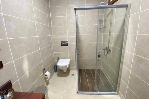 a bathroom with a shower and a toilet at Menzara Hotel & Restaurant in Sapanca