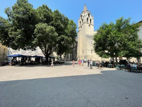 a group of people walking in front of a church at Studette avec le charme de l'ancien in Avignon