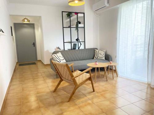 a living room with a couch and a table at Gravity Ialysos Scandi Suite in Ialyssos