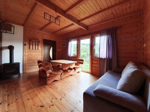 a living room with a couch and a table at Domek na Górce in Rabe