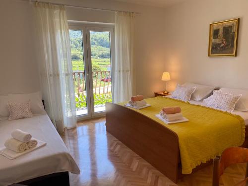 a bedroom with two beds with towels on them at Holiday home Mandi in Vrbanj