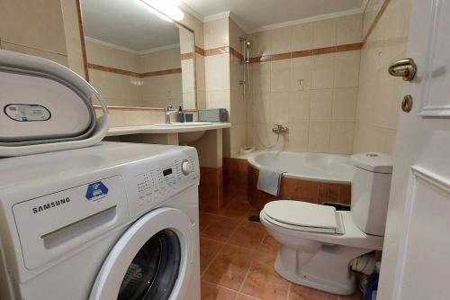 a bathroom with a washing machine and a toilet at Avli House in Heraklio Town