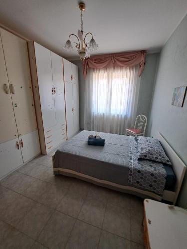 a bedroom with a large bed and a window at Stanze Del Corso in San Marco dei Cavoti