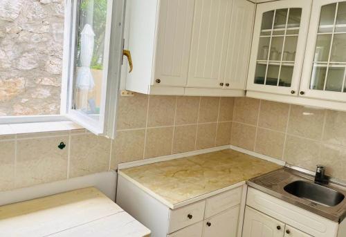 a kitchen with white cabinets and a sink at Blue Horizon in Novi Vinodolski