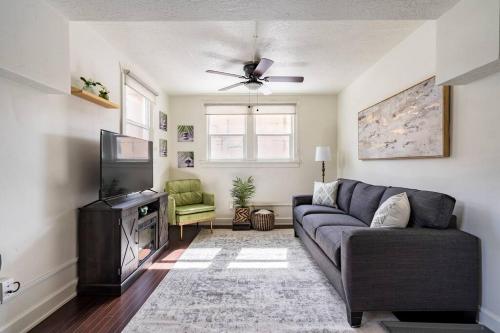 a living room with a couch and a tv at Lady Madonna Sage Flat in Salt Lake City