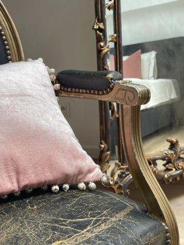 a chair with a pillow in front of a mirror at Art Loft in Sint-Martens-Latem