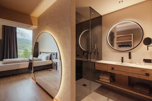 a bathroom with a sink and a mirror at Hotel Lech Da Sompunt in Badia
