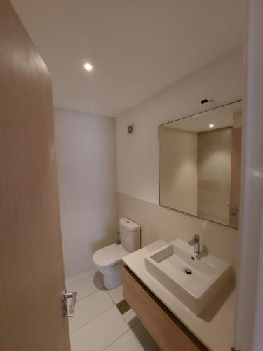 a bathroom with a sink and a toilet and a mirror at Marassi Marina in El Alamein