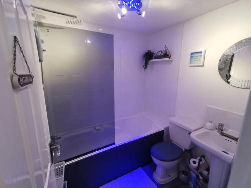 a bathroom with a tub and a toilet and a sink at Stunning 2-Bed House in Macclesfield Cheshire in Macclesfield