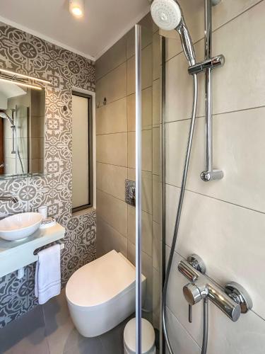 a bathroom with a toilet and a sink and a shower at Athanasia's House in Symi