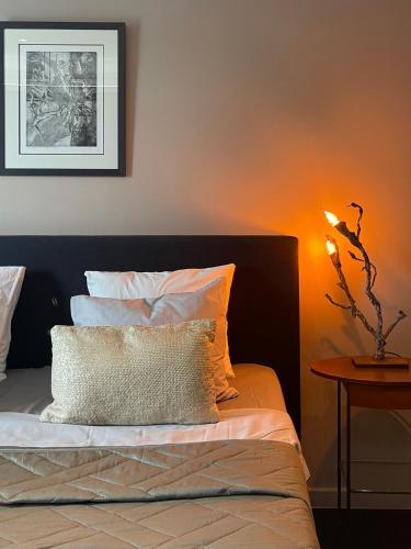 a bedroom with a bed and a table with a lamp at Art Loft in Sint-Martens-Latem