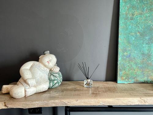a statue of a baby sitting on a table at Art Loft in Sint-Martens-Latem