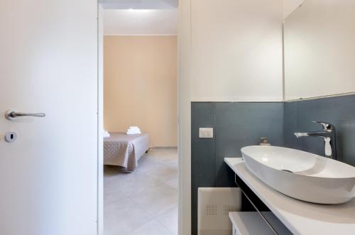 a bathroom with a sink and a mirror at Bonnystudios Holiday Apartments in Cagliari