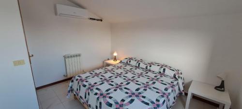 ein Schlafzimmer mit einem Bett und einem Tisch mit einer Lampe in der Unterkunft Casa Emma in Suvereto
