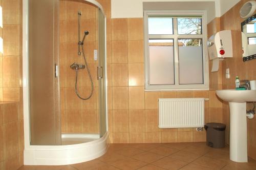 a bathroom with a shower and a sink at Eko Marina Mikolajki in Mikołajki