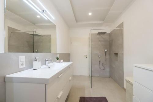 une salle de bain blanche avec lavabo et douche dans l'établissement Villa Nusa - Imotski- Brand new, à Imotski