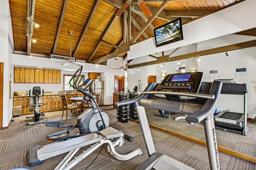 a fitness room with cardio equipment and a gym at Puunoa Beach Estates 103 in Lahaina