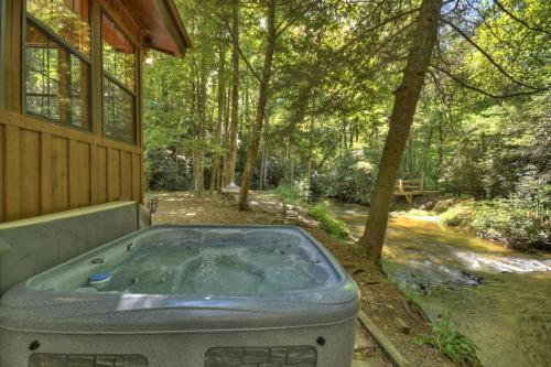 a jacuzzi tub sitting outside of a house at Keepin it Reel in Ellijay