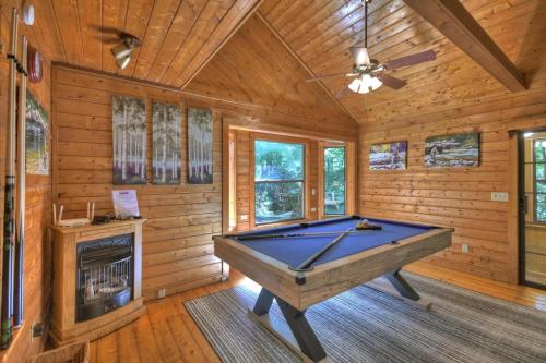 a pool table in a room with a fireplace at Keepin it Reel in Ellijay