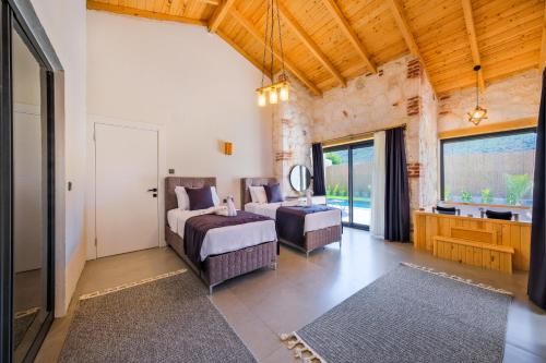a bedroom with a bed and a couch and windows at Fethiye Villa Ka Exclusive 1 in Fethiye