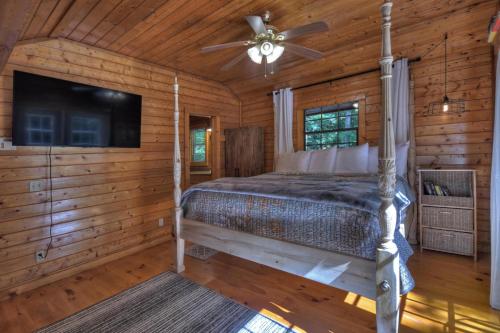a bedroom with a bed and a ceiling fan at Keepin it Reel in Ellijay