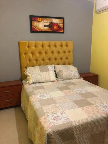 a bedroom with a bed with a quilt on it at El sueño de Maria in Veracruz