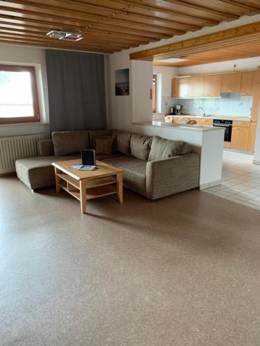 sala de estar con sofá y mesa en Ferienwohnungen Paukner en Sankt Englmar