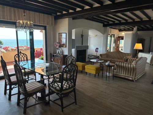 a living room with a table and chairs and a couch at Piccadilly Penthouse with Jacuzzi in Lido di Camaiore