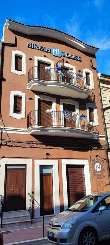 a building with a car parked in front of it at Miryam House Affittacamere Suite e Relax in San Severo