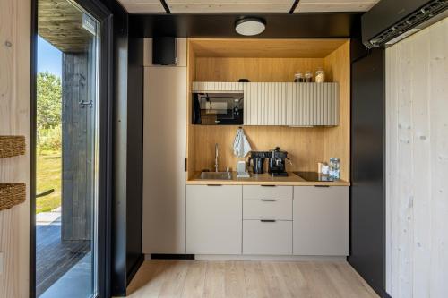 a kitchen with white cabinets and a sink at VyriY House in Lis