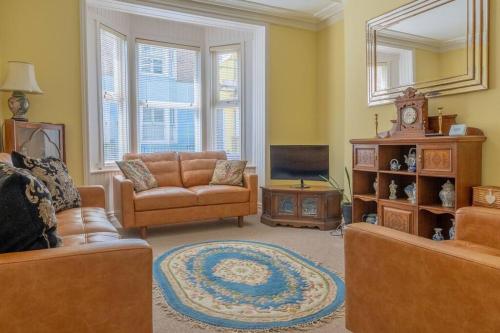 a living room with two couches and a tv at Elegant Family Townhouse-Conservation Area-Garden in Kent