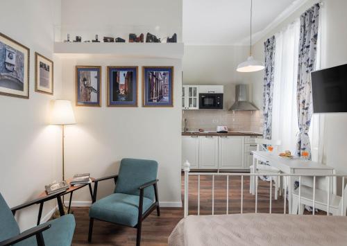 a living room with a bed and a kitchen at Photel Apartments in Crikvenica