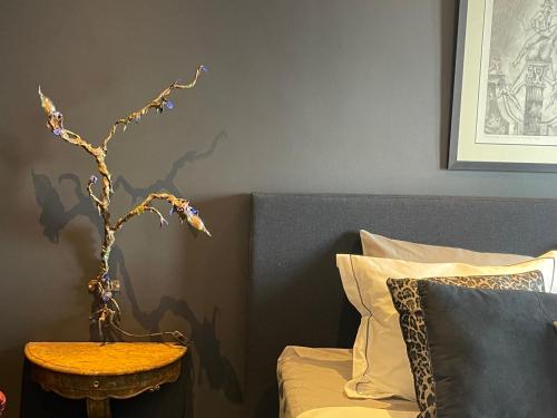 a bedroom with a bed with a table next to a bed at Art Loft in Sint-Martens-Latem