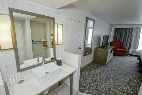 a bathroom with a sink and a mirror at Country Inn & Suites by Radisson, New Orleans I-10 East, LA in New Orleans