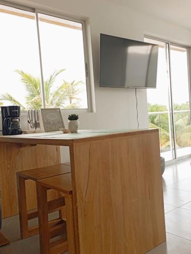 a kitchen with a counter with a large window at NAHIR apartamento de playa en condominio Palmar del viento in San Bernardo del Viento