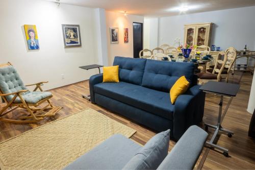a living room with a blue couch and a table at QualiteGuest/ Departamento Polanco/CDMX in Mexico City