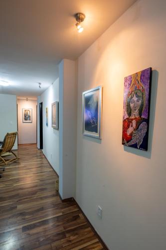 a hallway with paintings on the wall at QualiteGuest/ Departamento Polanco/CDMX in Mexico City