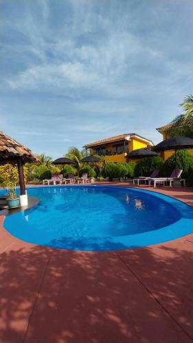 a large blue swimming pool in front of a building at Hotel Jardín Garden de Granada Nicaragua in Granada
