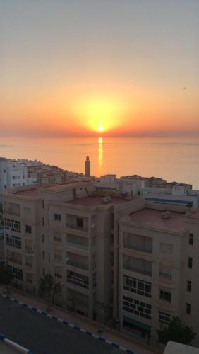a sunset over the ocean in a city with buildings at Welcome to THE VIEW! in Al Hoceïma