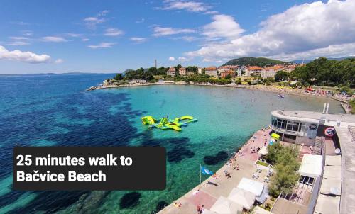 a beach with a pool and people in the water at Apartment Elizabeth in Split