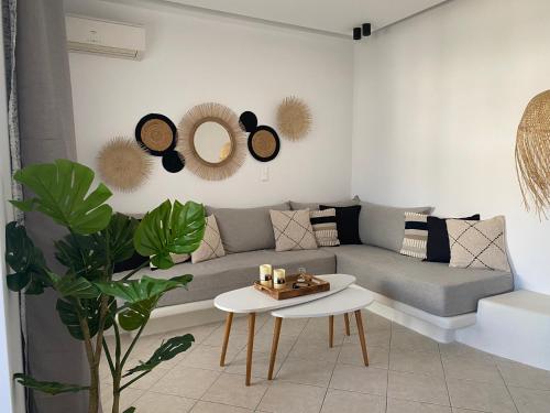 a living room with a couch and a table at Casa AMARE - Naxos in Naxos Chora