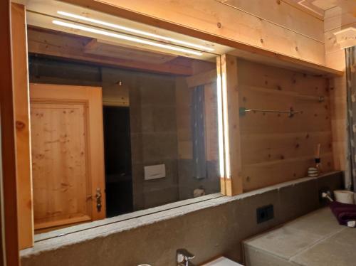a mirror above a sink in a bathroom at Bio Bauernhof Perneißl Apartment in Bischofshofen