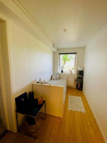 a small room with a bed and a window at Brunns Lake House in Ulricehamn