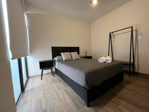 a bedroom with a bed and a table and a mirror at #1 Edificio Tía Flora in León