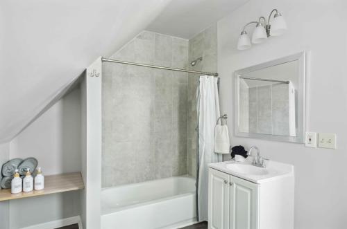 a white bathroom with a shower and a sink at Detroit 2Bd Christmas Holiday Museums Parks in Detroit