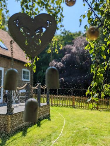 a heart sculpture in the yard of a house at Myrtle Stables - converted, self-contained, countryside in Hernhill