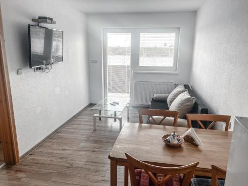 a living room with a table and a couch at Rezidencia Podhájska in Podhájska