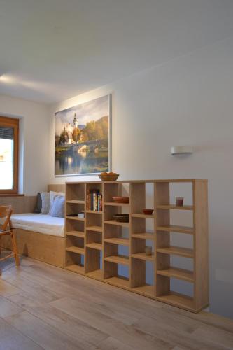 a bedroom with a bed and a book shelf at APARTMA VODNIK in Bohinj